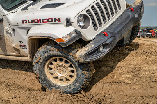 Loveland, CO, USA - August 27, 2023: Jeep Wrangler, Rubicon model, on a muddy training drive off-road course