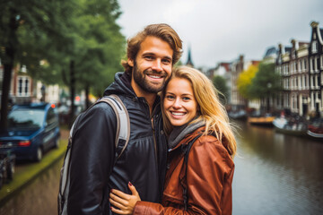 Obraz premium Multiethnic couple traveling in Amsterdam in autumn. Happy young travelers exploring in city.