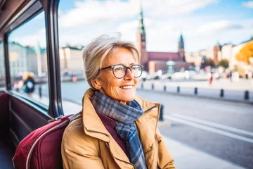 Foto auf Glas Woman traveling in Stockholm. Happy older traveler exploring in city. © Katrin Kovac