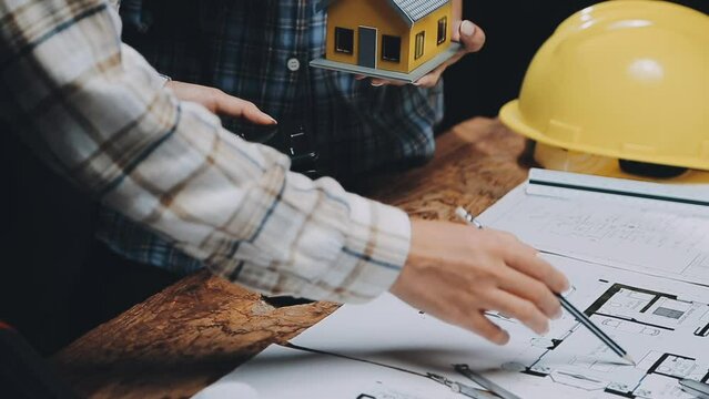 Image of team engineer checks construction blueprints on new project with engineering tools at desk in office.