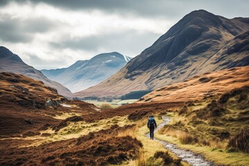 Fototapeta premium Man traveling in Scottish highlands. Happy young traveler exploring in nature.