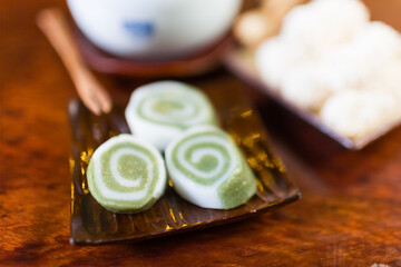 Dish of Tteok, glutinous rice cakes, on a wooden table