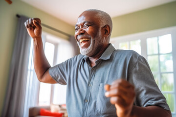 Positive black older man dancing at home. Happiness and well being concept.