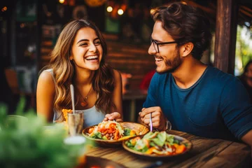 Zelfklevend Fotobehang Young couple eating mexican food at restaurant. Couple on date night with delicious food. Generative AI © Katrin Kovac