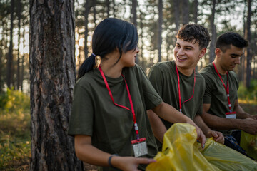 teenage friends young men women pick up waste garbage to clean forest