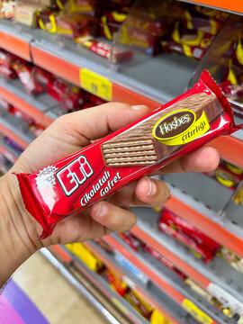 Close up view of a hand holding famous Turkish snack brand's package in supermarket