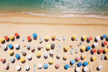 Beach with lounge chairs and umbrellas, view from above