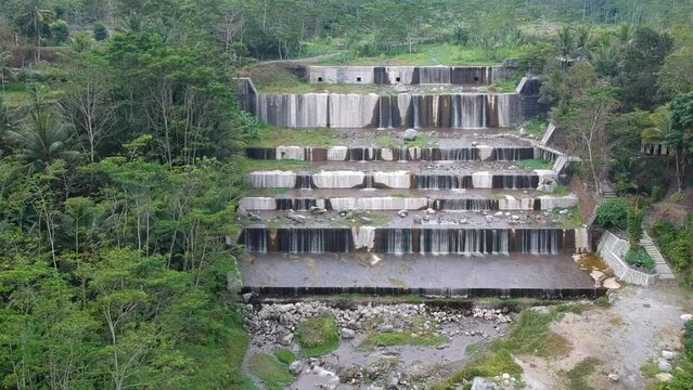 Aerial footage of the Watu Purbo sabo dam in Sleman, Indonesia which has a 6-level water dam. Apart from preventing the eruption of Mount Merapi, this dam is also a popular tourist destination
