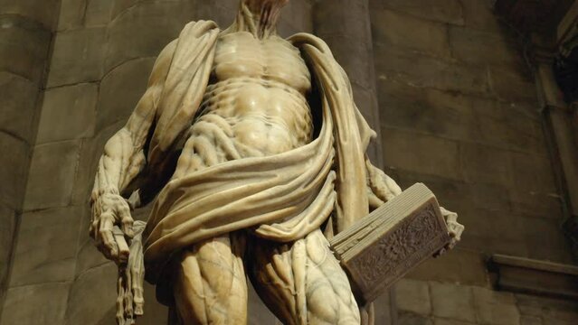 Closeup shot of the famous statue of Saint Bartholomew skinned, made by the sculptor Marco d’Agrate in 1562, in the Milan Duomo Cathedral in Milan, Italy.