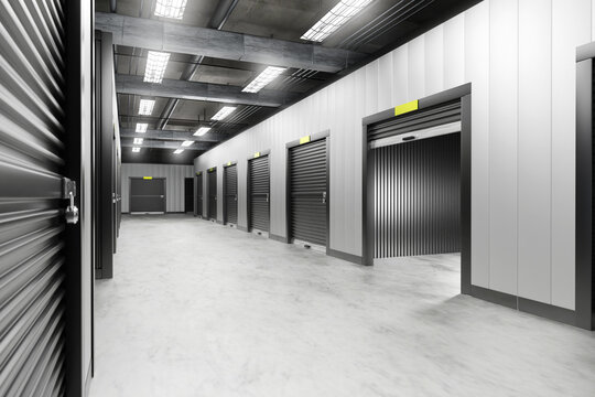 Empty building with storage rooms. Warehouse corridors with gates to units. Storage rooms for long-term rental. Interior of warehouse. Storage rooms for safekeeping furniture. 3d image