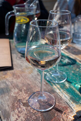 Drinking pinot grigio dry cold wine, served outdoor in beach cafe in North Holland, North sea sandy beach, the Netherlands
