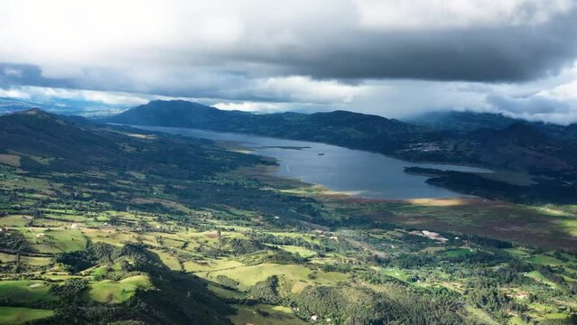 Surreal Drone Hyperlapse: Time-Lapse Journey Over a Lake Encircled by Majestic Mountains &ndash; Dark Clouds Adding a Mysterious Aura to the Scenic Landscape Embalse de Tomine