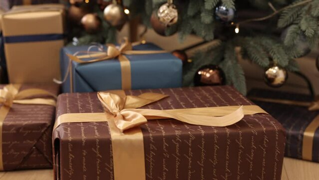 New Year, Christmas gift, Christmas gift boxes. Many gift boxes tied with ribbons and decorations, a Christmas background, beautiful Christmas gift boxes on the floor near the fir tree in the room