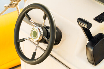 Modern rudder next to the throttle inside the yacht.