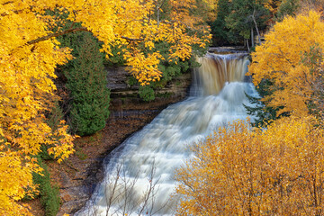 Laughing Whitefish Falls in Autumn in Michigans Upper Peninsula. Waterfall surrounded with autumn color.