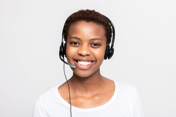 Close up shot on beautiful white smile. Afro american woman in call centre working receiving call...