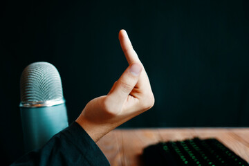 Streamer show gestures. Gamer shows the middle finger.