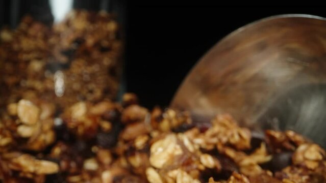 The camera moves backward as I scoop granola with a spoon, for breakfast, in slow motion.