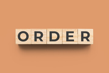 Order wooden cubes on orange background