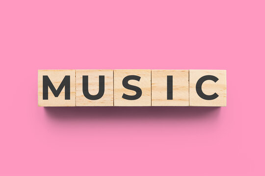 Music wooden cubes on pink background