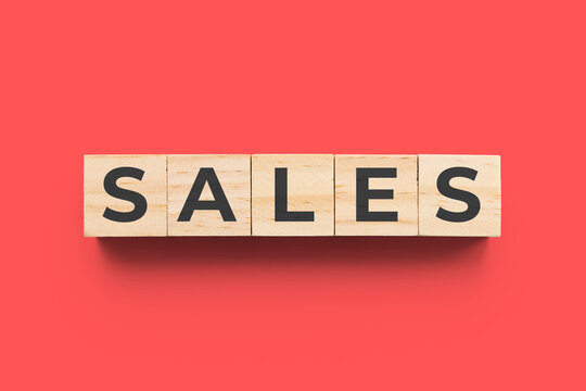 Sales wooden cubes on red background