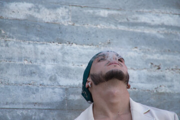 Latin and Hispanic boy, young and nonconformist, rebellious, with a handkerchief on his head,...