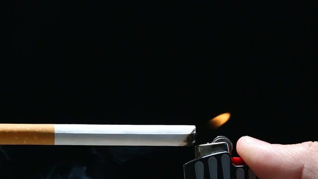 Burning cigarette with smoke and concept of cigarettes