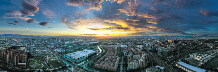 Stunning Aerial Panoramic View of Bogotá Skyline at Sunset – Golden Hour Casting Warm Hues Over...