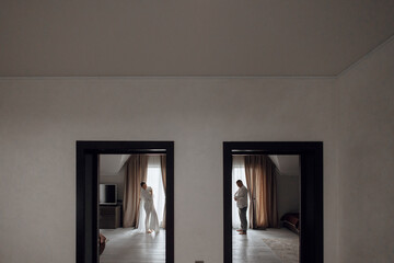 the bride wears a wedding dress. The groom wears a white shirt. Mirror image