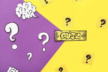 Paper quiz card with question marks on color background