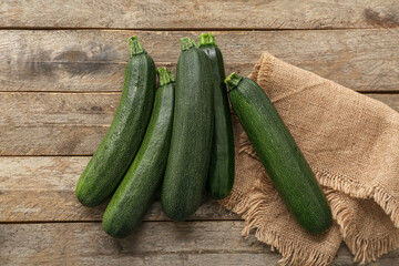 Many fresh zucchini on brown wooden background