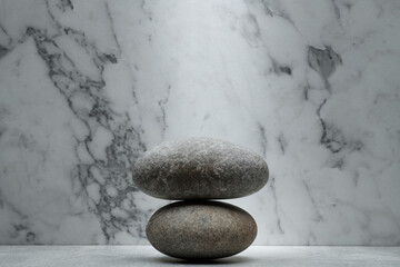 black gray white stones for the podium on a marble background for product presentation