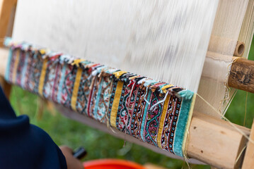 Carpet weaving using traditional techniques on a loom. , close-up of weaving and handmade carpet...