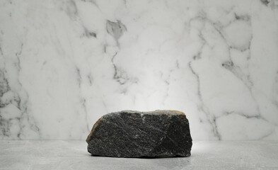 black gray white stones for the podium on a marble background for product presentation
