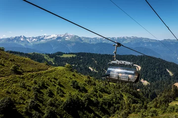 Tuinposter Carousel cable car in the mountains © daniiD