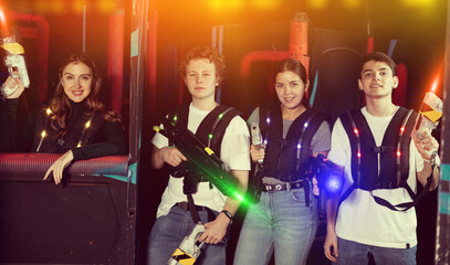 Triumphing team of laser tag winners guys and girls