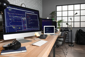Programmer's workplaces with computer monitors in office
