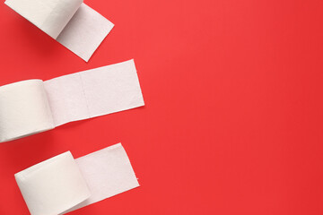 Rolls of toilet paper on red background