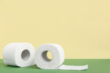 Rolls of toilet paper on green background