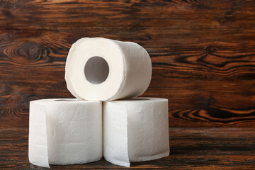 Rolls of toilet paper on wooden background