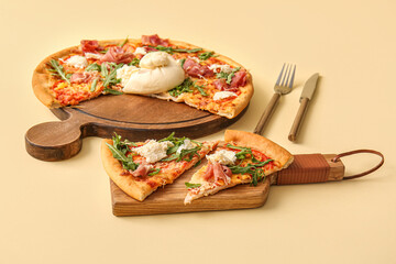 Slices of tasty pizza with Burrata cheese on yellow background