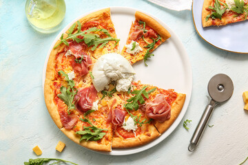 Plate of tasty pizza with Burrata cheese on blue background
