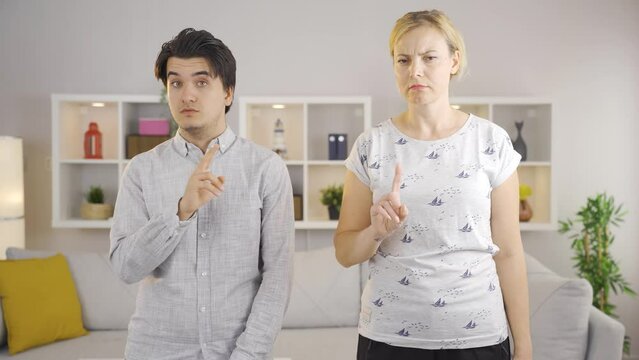 Mom and son are listening and looking at camera says no.