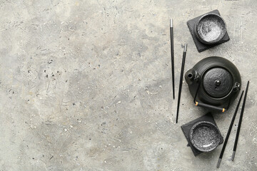 Chinese table setting with teapot on grunge background