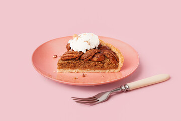 Plate with piece of tasty pecan pie on pink background