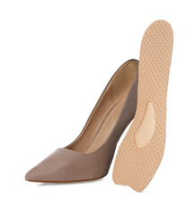 Orthopedic insole near high heel shoe on white background