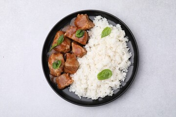 Delicious goulash with rice on light grey table, top view