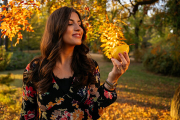 Pretty young woman eating pear in the park 