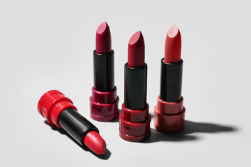 Obraz premium Different new stylish lipsticks on light background, closeup