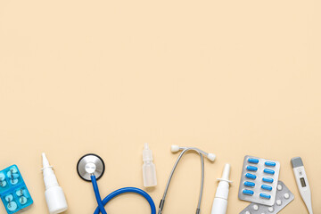Medical supplies with nasal drops on beige background